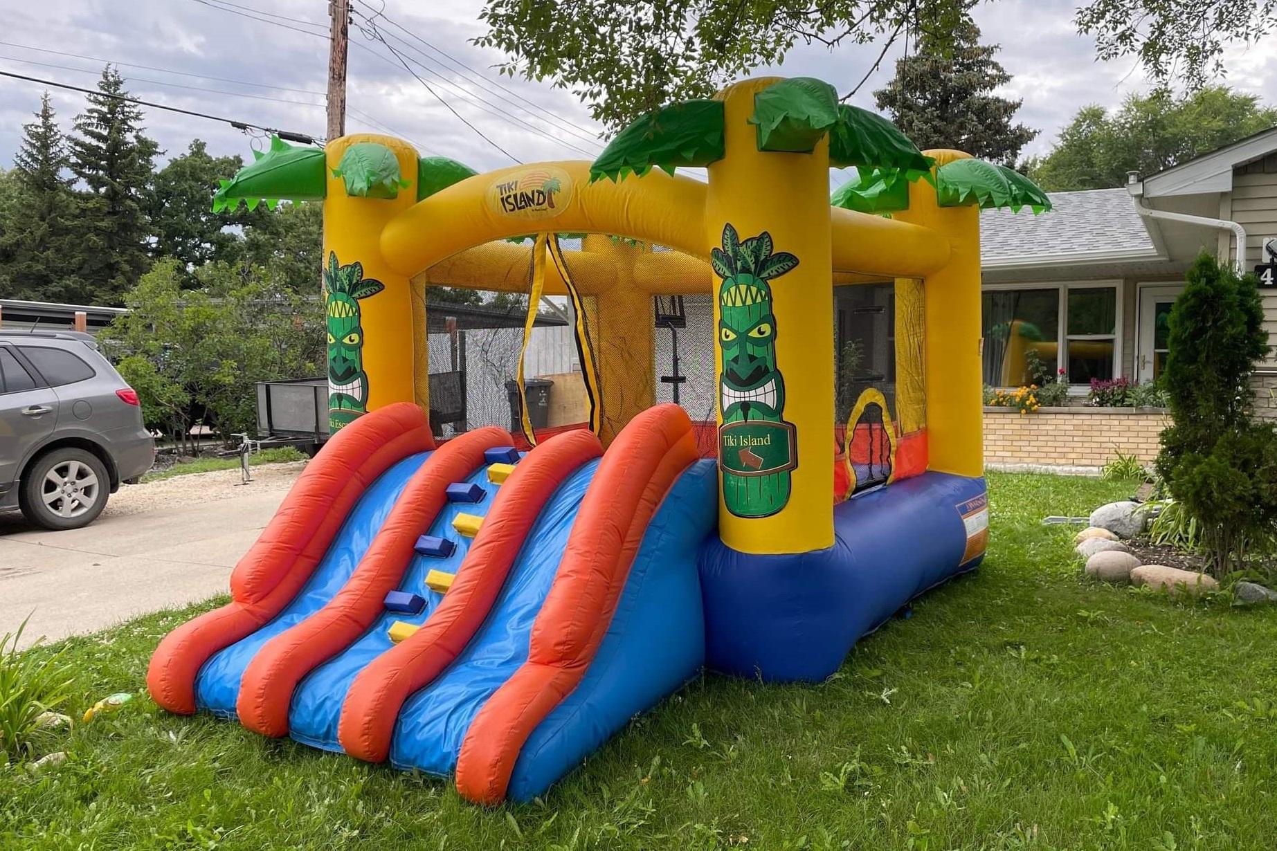 Tiki Island Bouncy Castle with slide party rentals Winnipeg Manitoba and Kenora Ontario