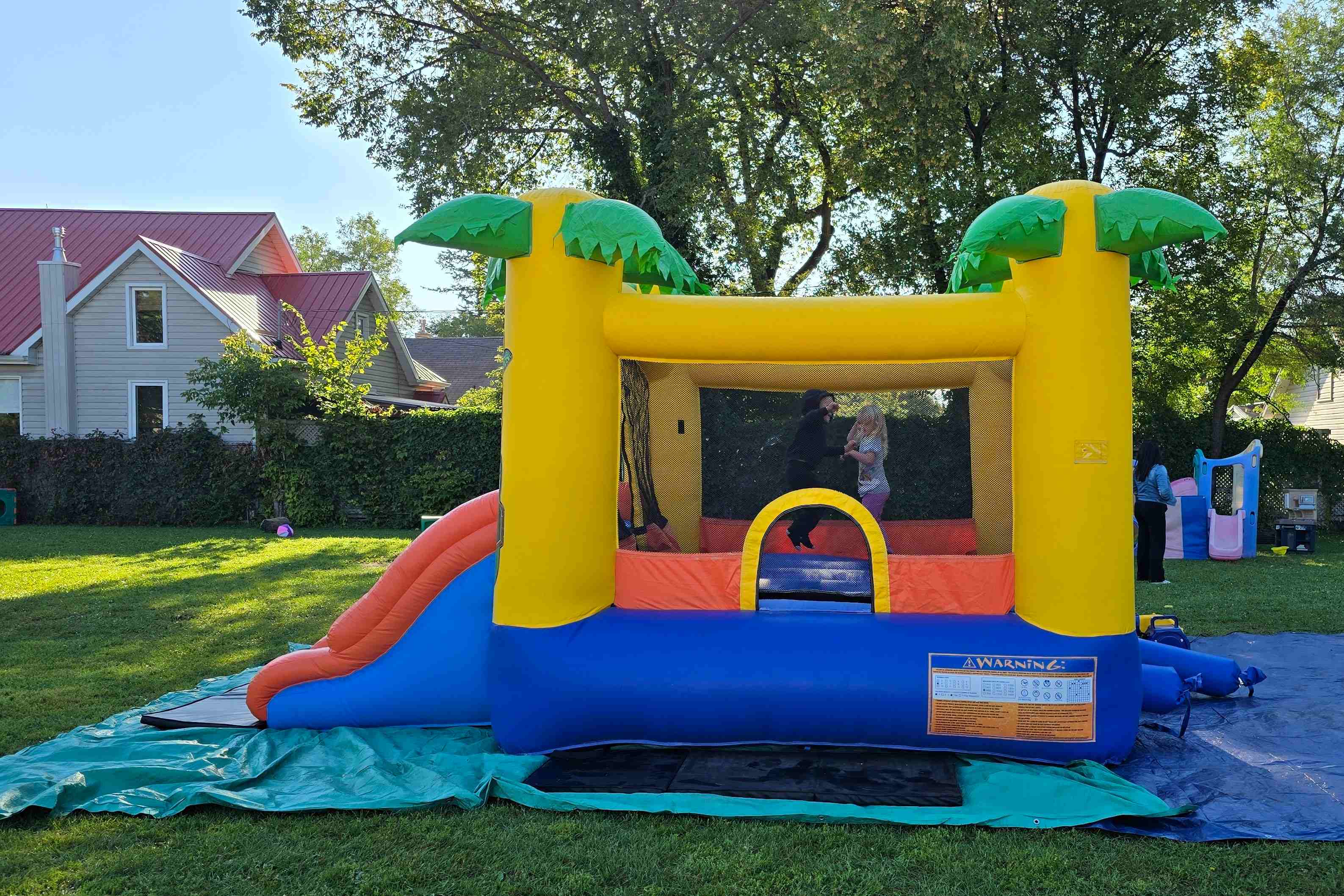 Tiki Island Bouncy Castle with slide party rentals Winnipeg Manitoba and Kenora Ontario