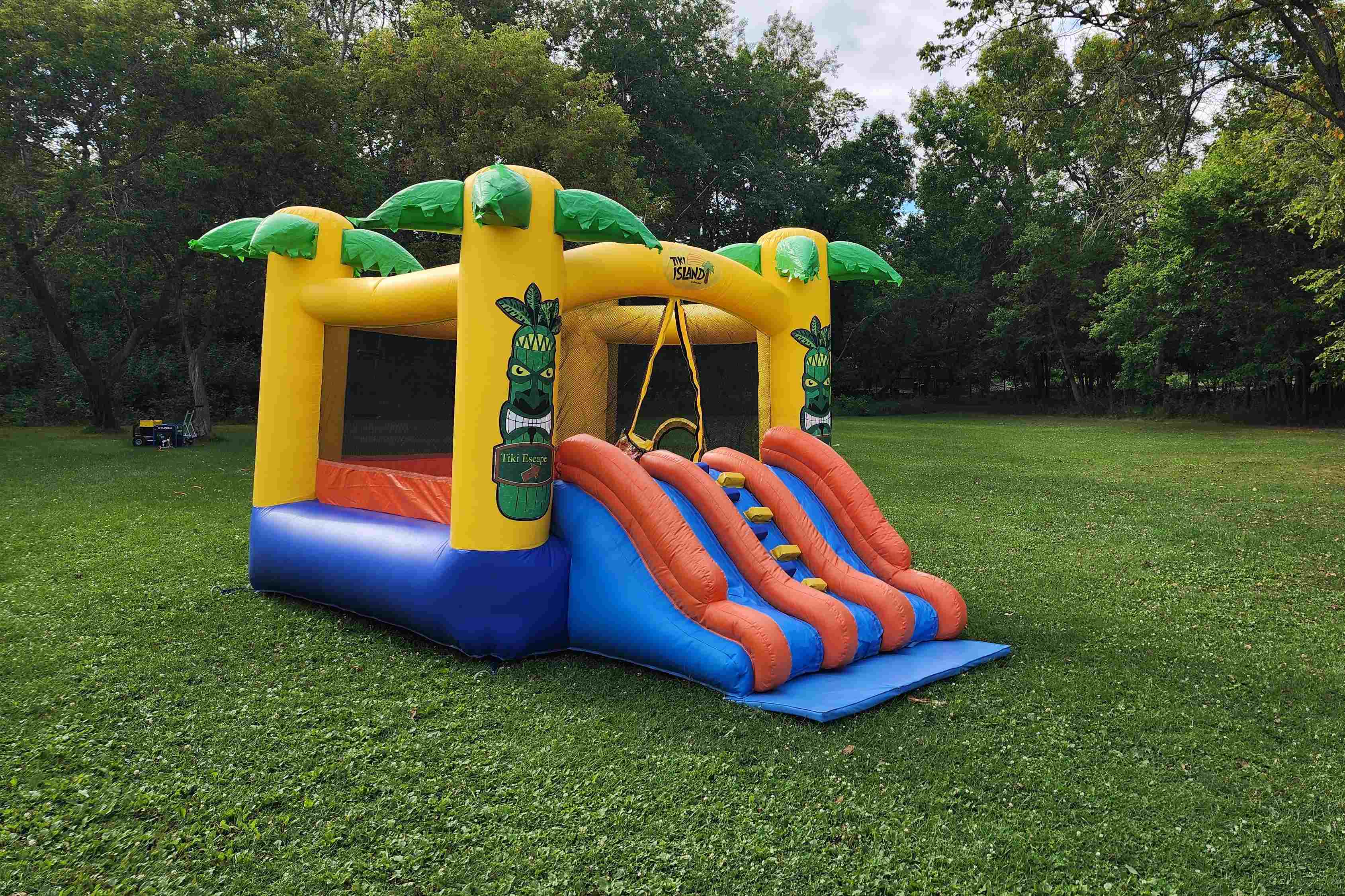 Tiki Island Bouncy Castle with slide party rentals Winnipeg Manitoba and Kenora Ontario