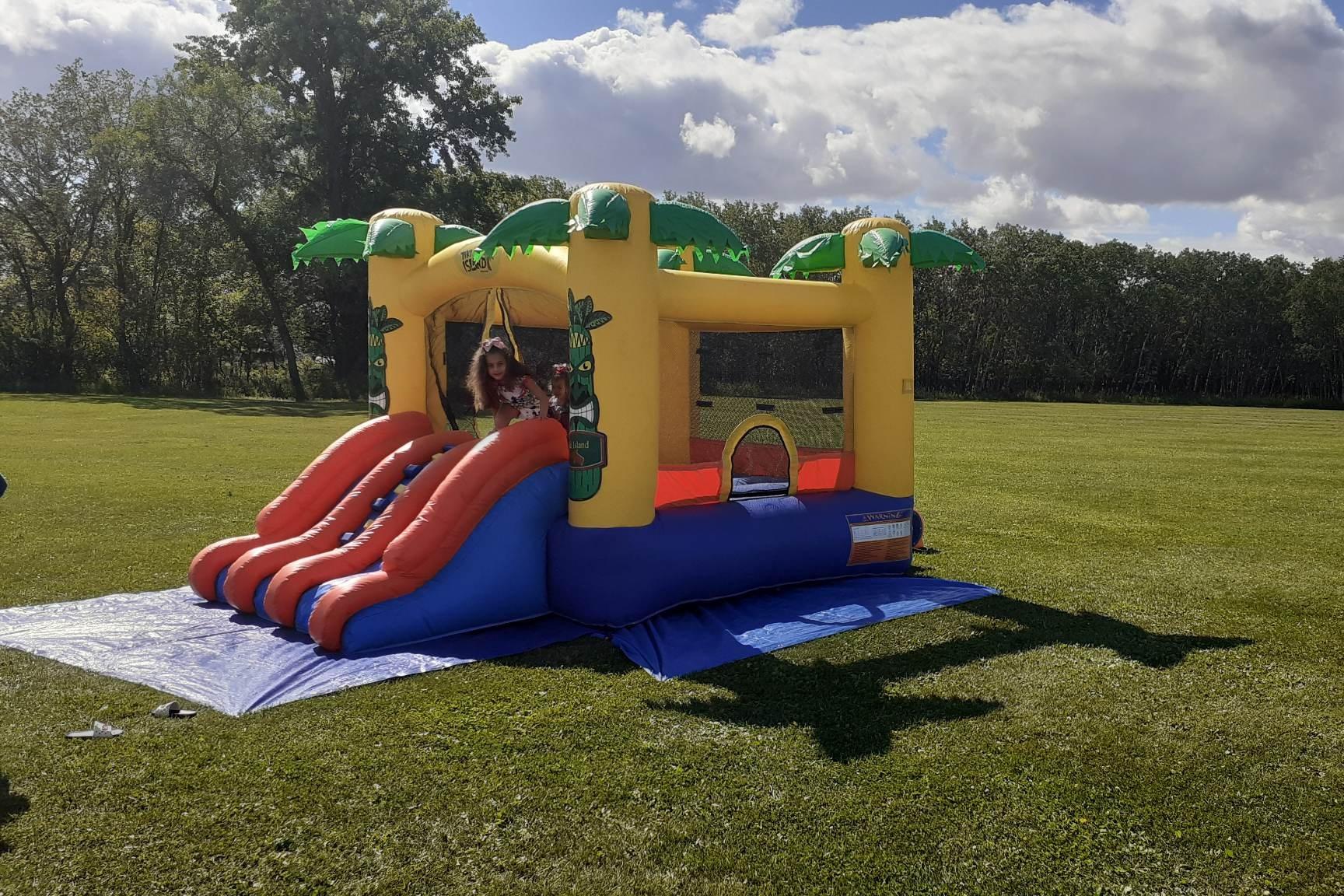 Tiki Island Bouncy Castle with slide party rentals Winnipeg Manitoba and Kenora Ontario